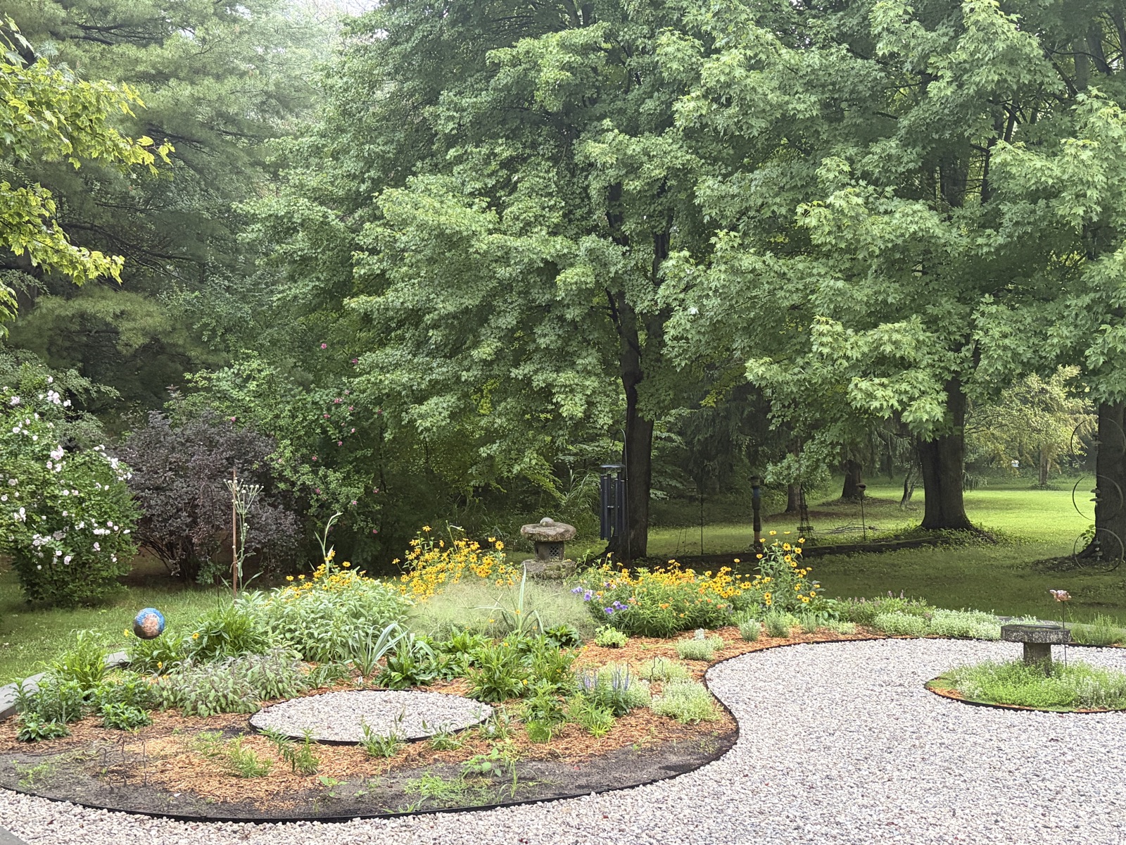 Wooded garden with gravel path and stone lantern